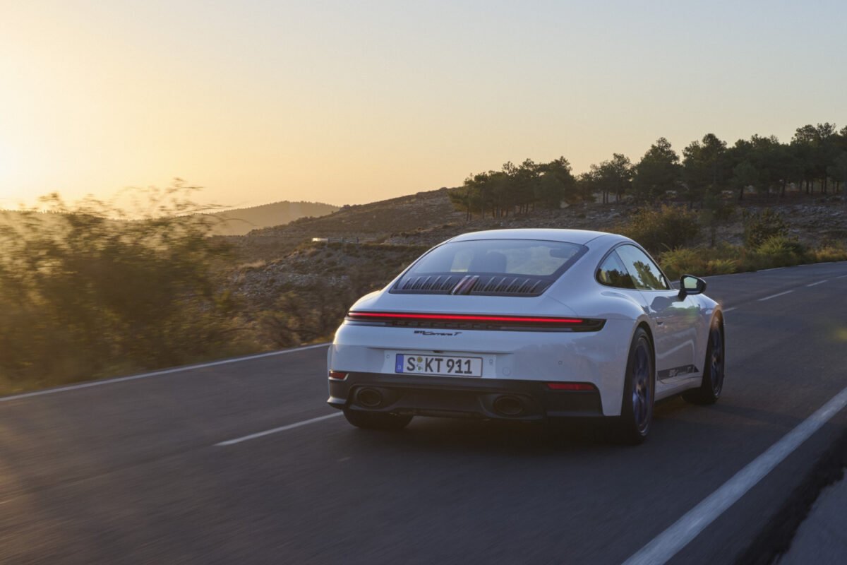 2025 Porsche 911 Carrera T on the road at sunset rear